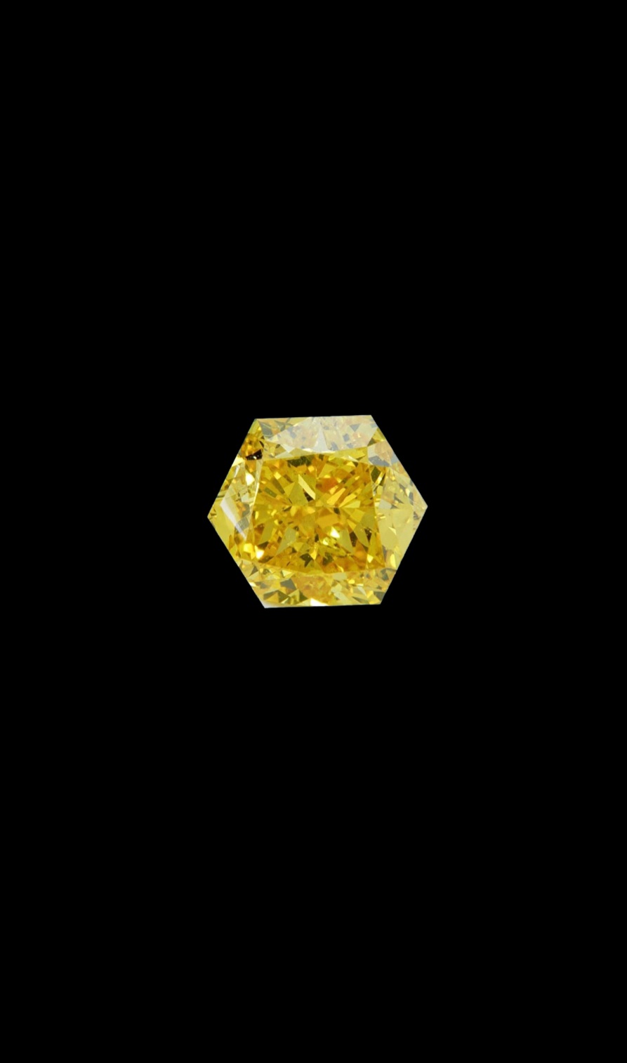 Fancy Vivid Yellow lab-grown diamond, hexagon cut, on black velvet — IGI Fancy Vivid certified