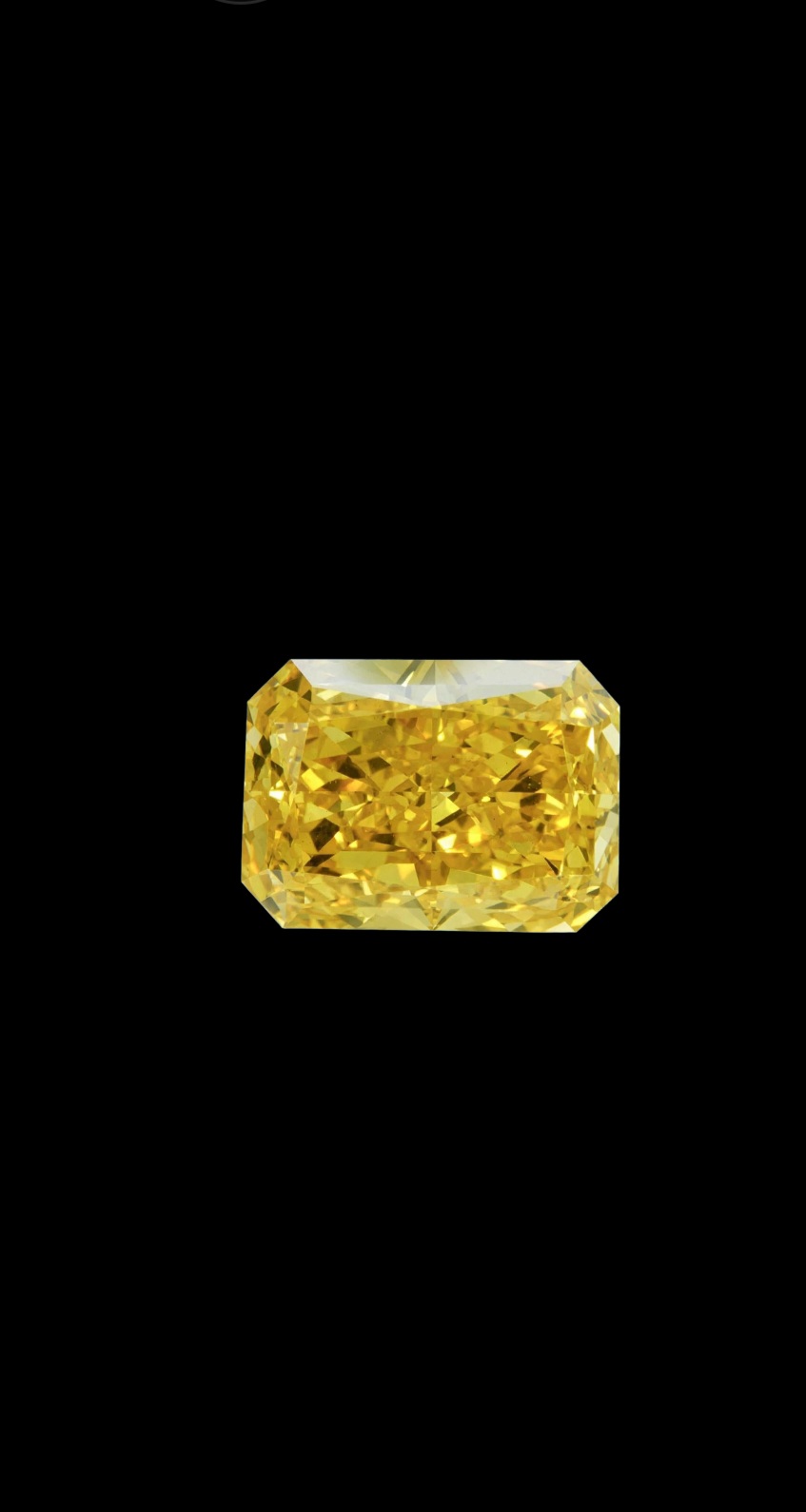 Fancy Vivid Yellow lab-grown diamond, radiant cut, on black velvet — IGI Fancy Vivid certified