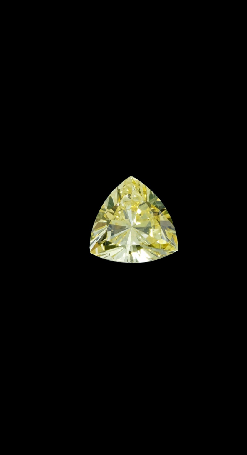 Fancy Vivid Yellow lab-grown diamond, trillion cut, on black velvet — IGI Fancy Vivid certified