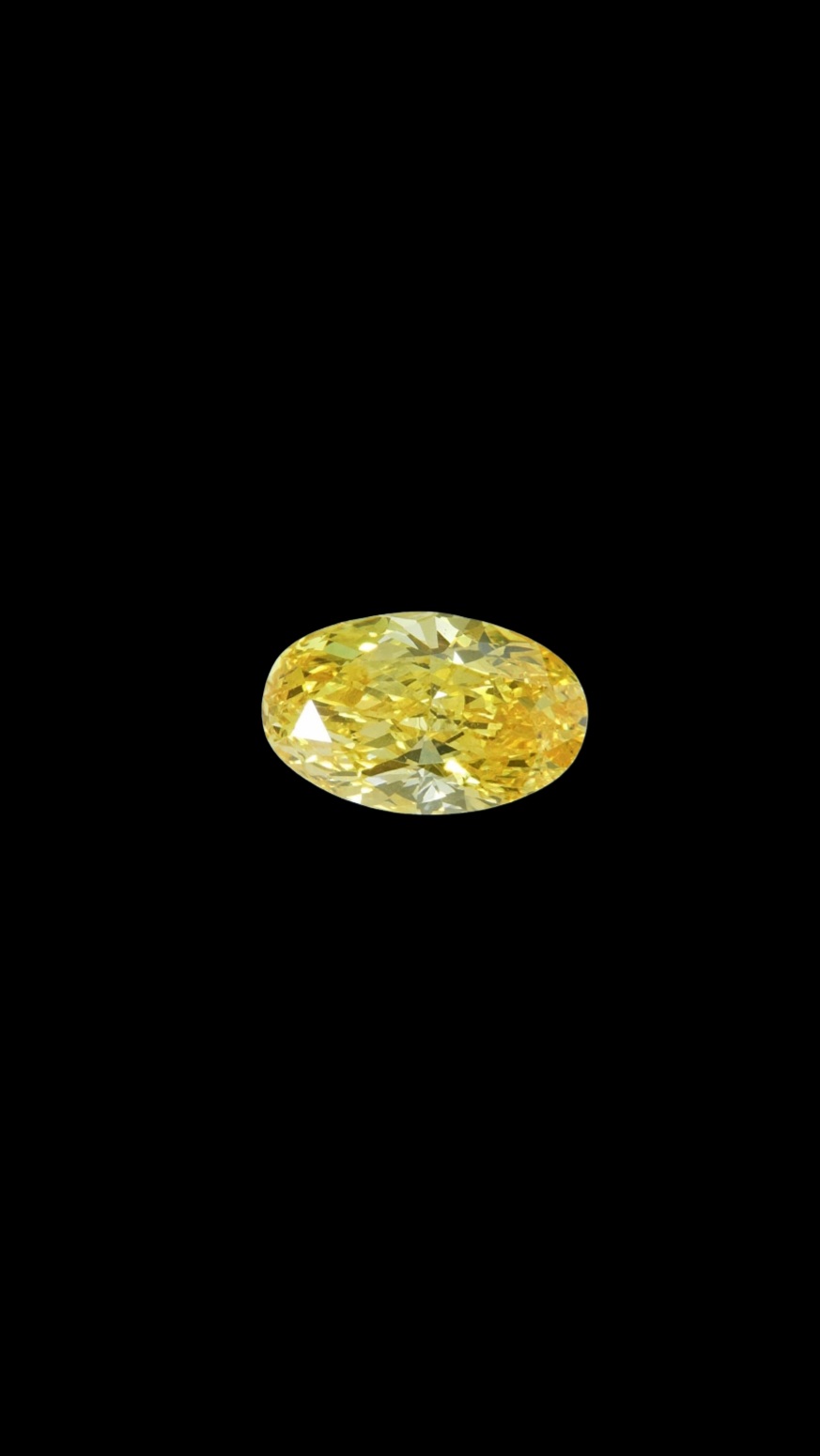 Fancy Vivid Yellow lab-grown diamond, oval cut, on black velvet — IGI Fancy Vivid certified