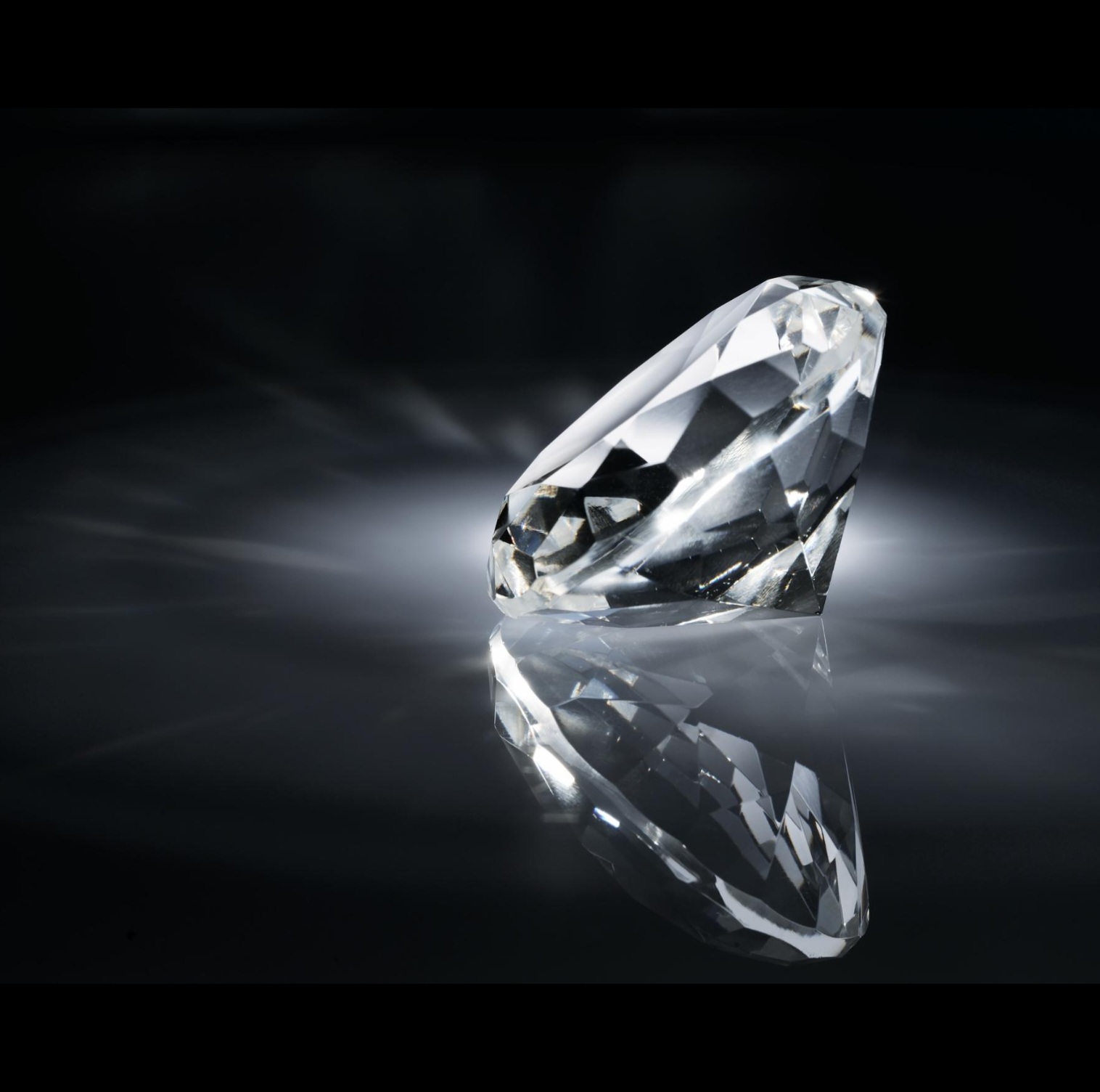 Solitaire lab-grown diamond photographed against deep black